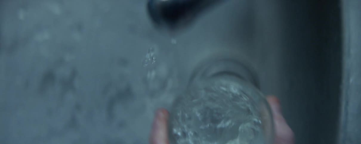 Man fills a glass with tap water