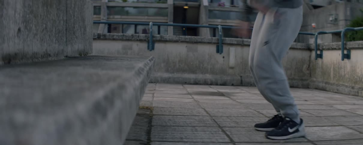 Man hops up to a ledge then hops back down