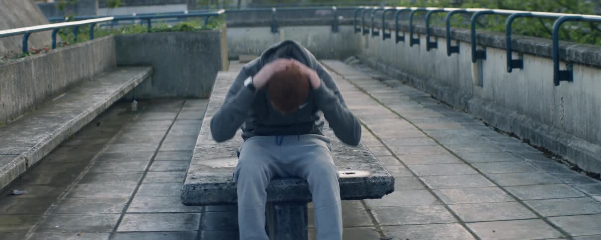 Man does sit ups on a stone bench