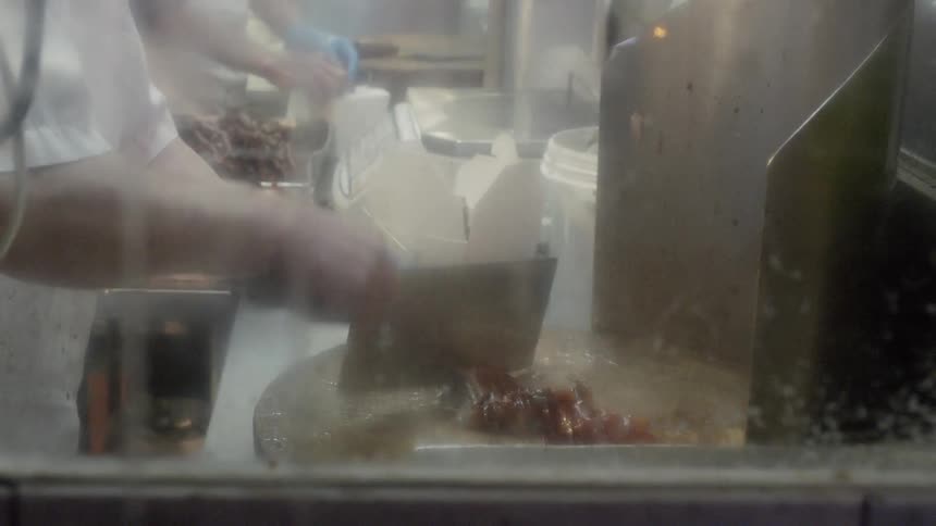 People are chopping meat in the restaurant