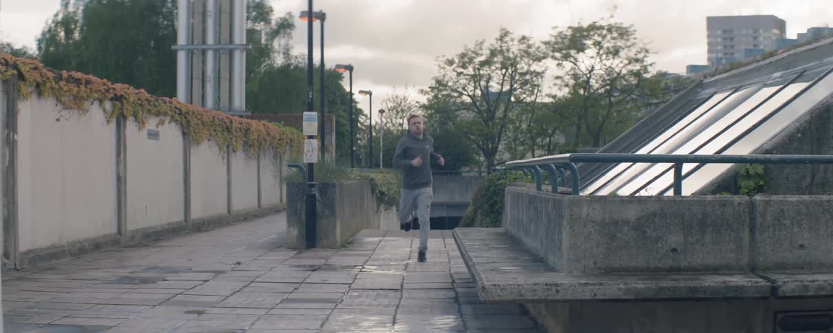 A man is running up the steps before taking a breather