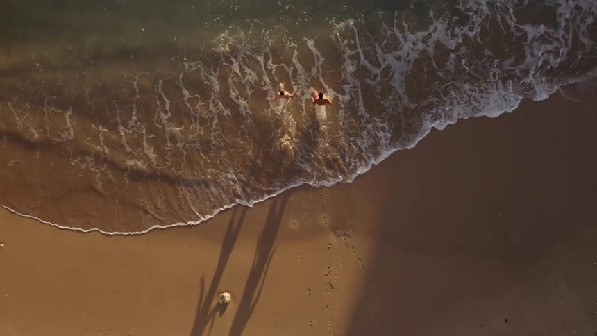 People run into ocean waves