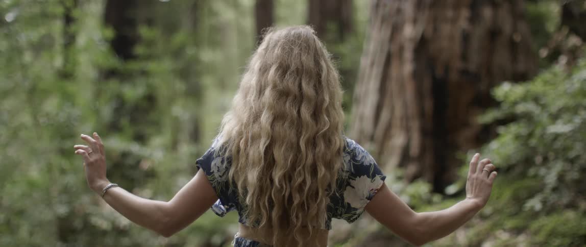 Woman stands in a forest