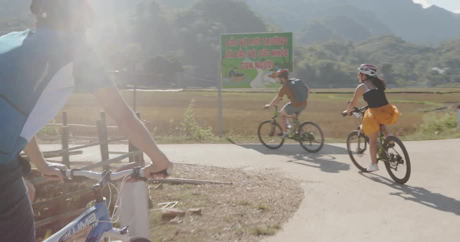 Bicyclists ride on a rural road