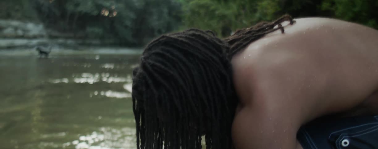 A man washes himself in the stream