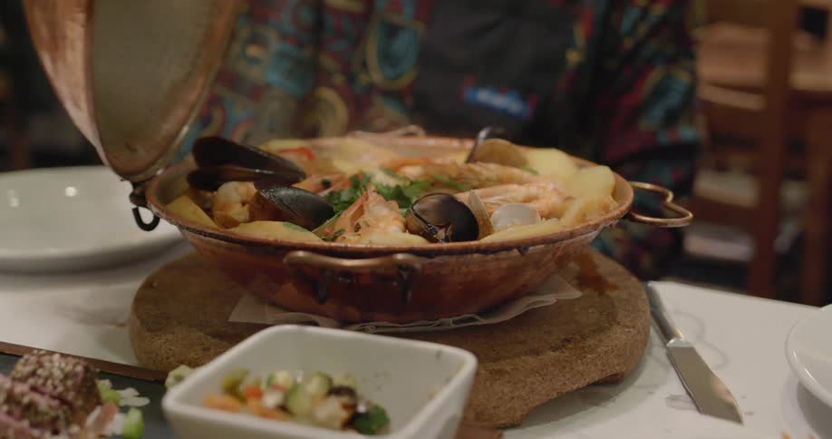 A person opens up a bowl of food