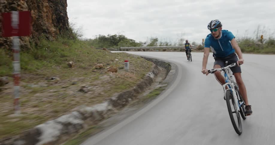 Bicyclists ride on a rural road