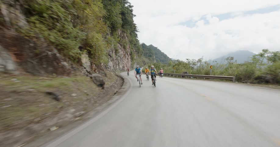 Bicyclists ride on a mountain road