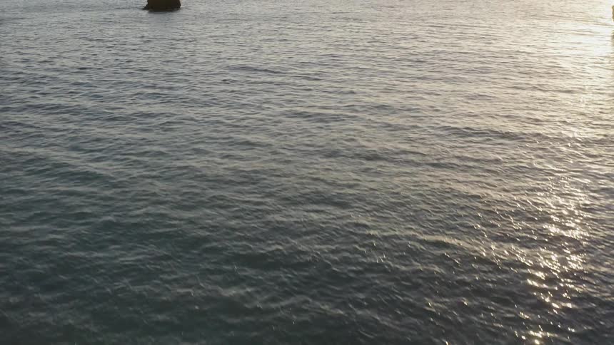 Two men stand in the ocean waters
