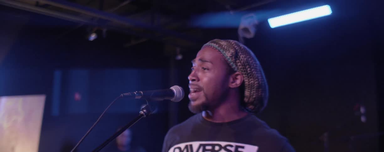 Man performing song before microphone