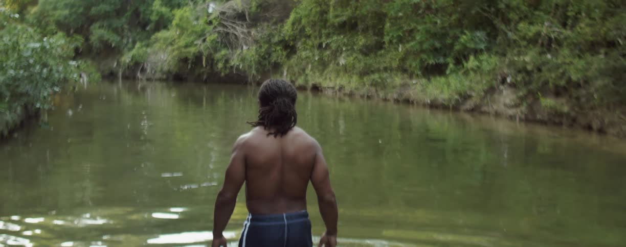 A man wades into a pond