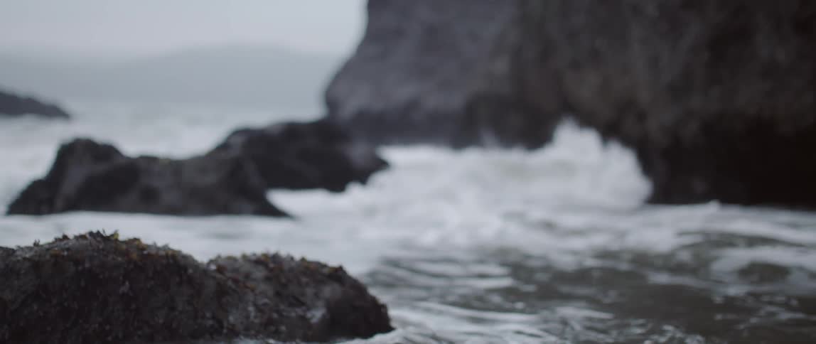 Ocean waves crash into rocks