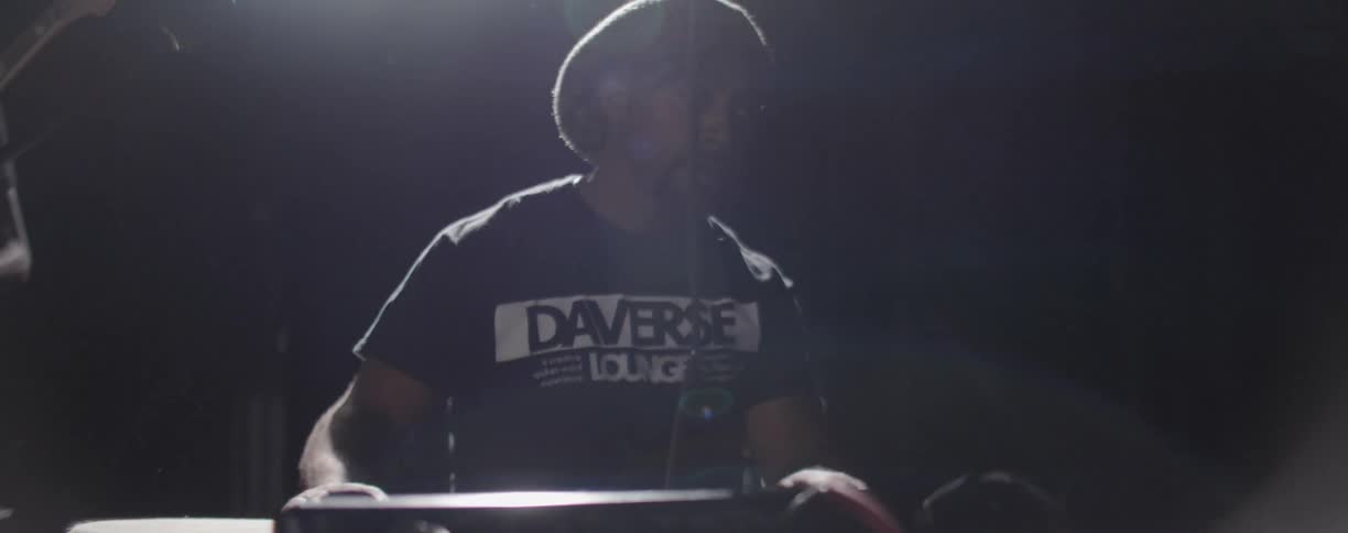 Man plays drums on a stage