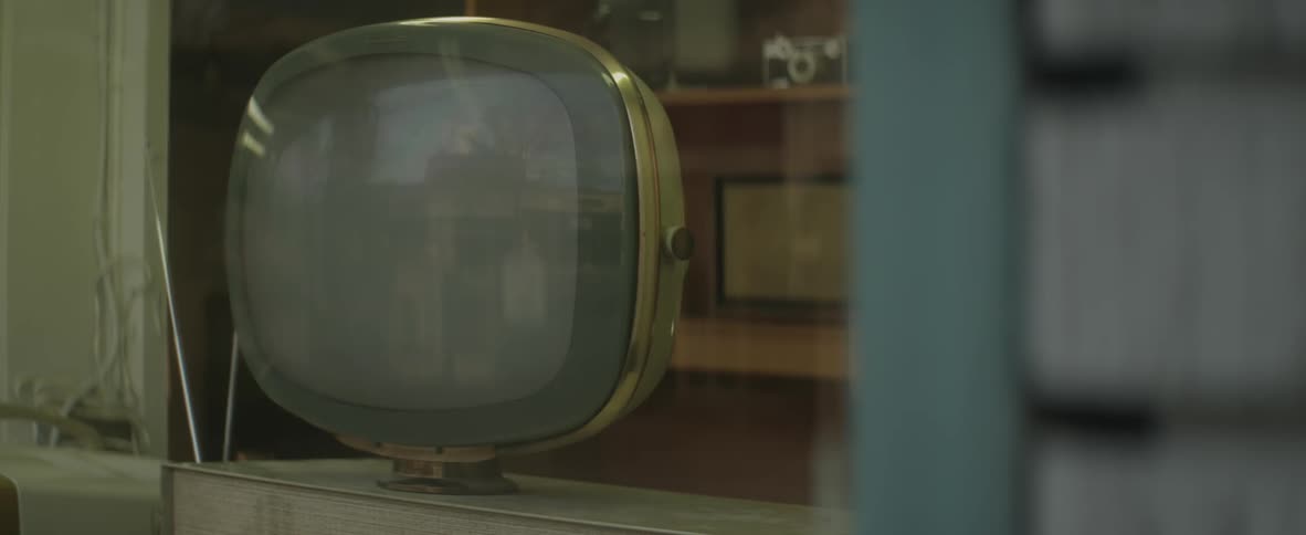 An old television with a curved brass case
