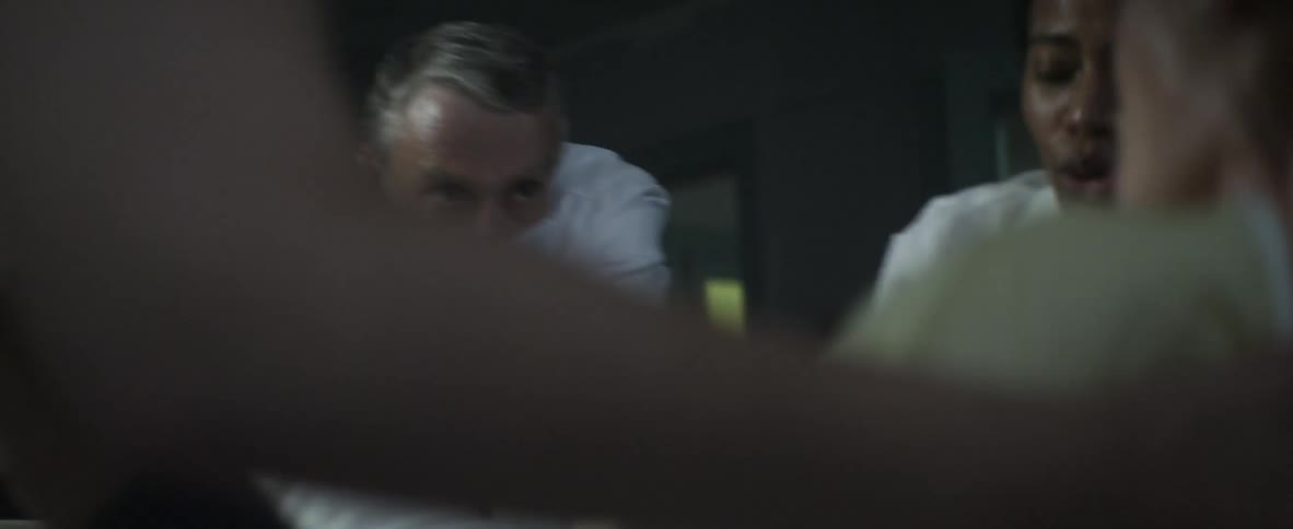 A doctor and nurse assist a woman giving birth
