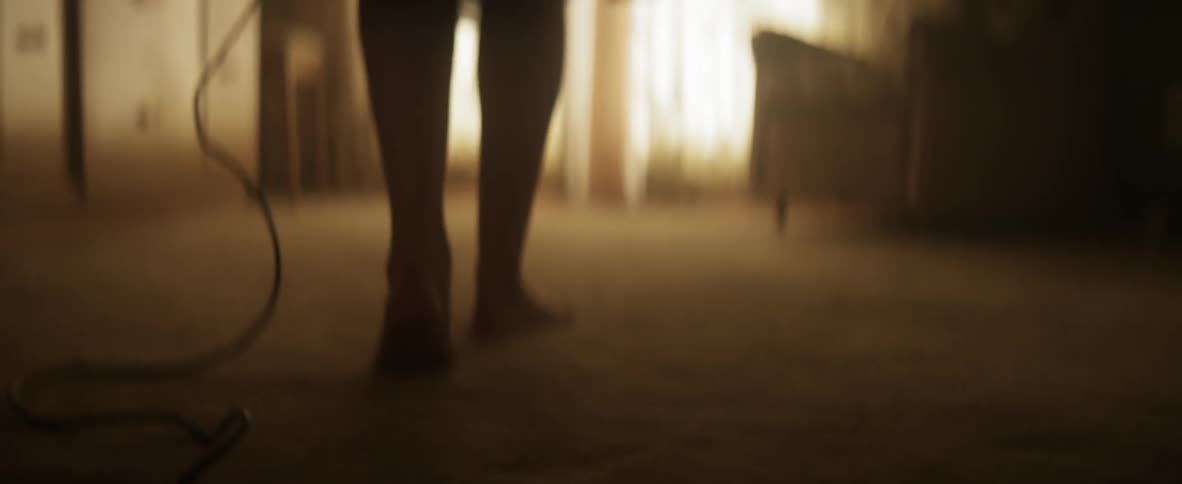 Person walking across a room holding  wire