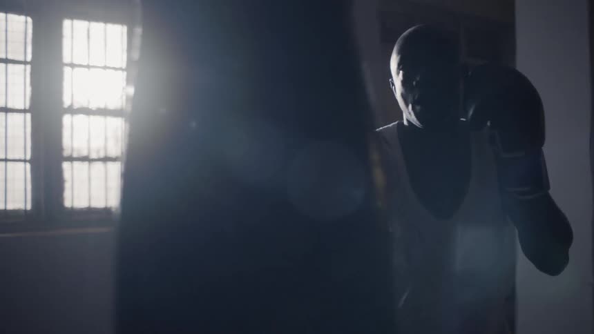 A man is punching the heavy bag