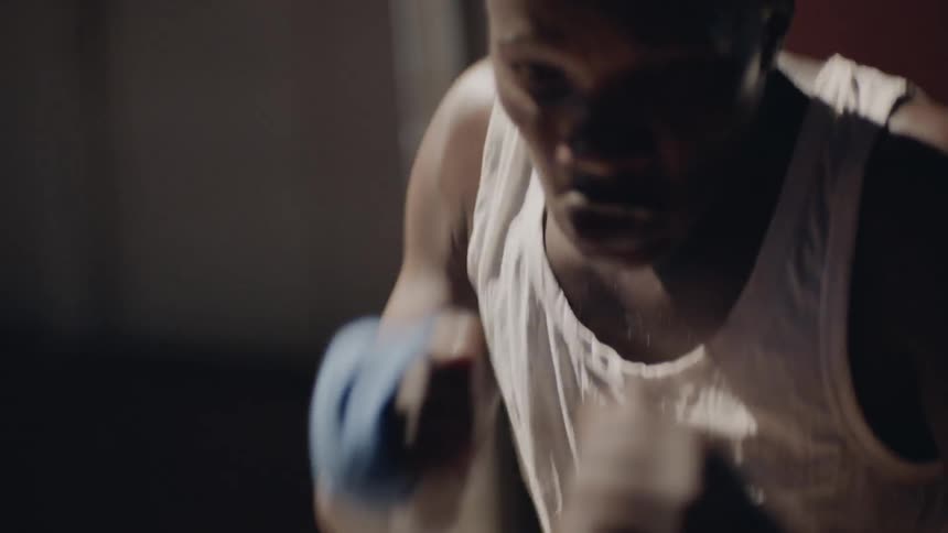 A man throws punches to train for boxing