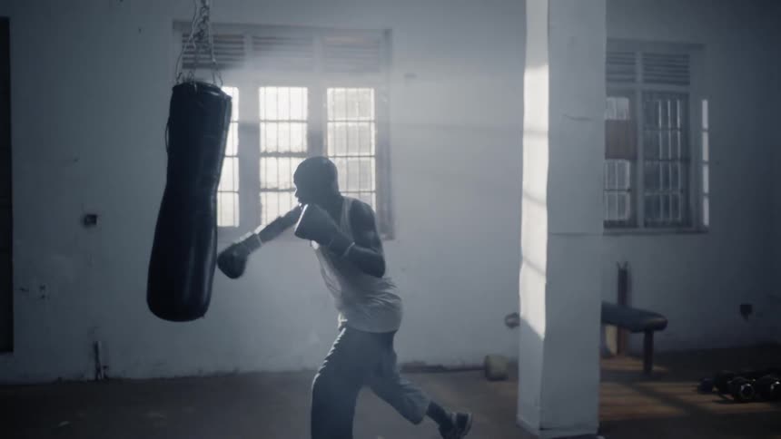 A boxer hits a punching bag