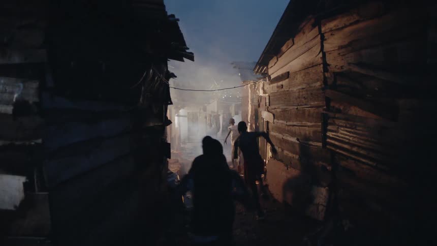 Children run frantically through a shanty town