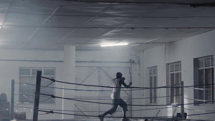 Man practices boxing jabs in a boxing ring