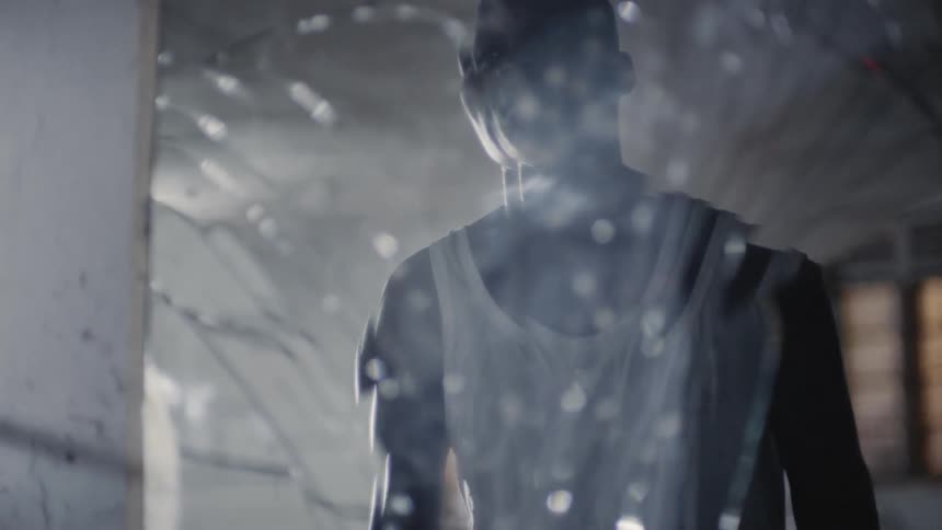 A man looks in the broken mirror