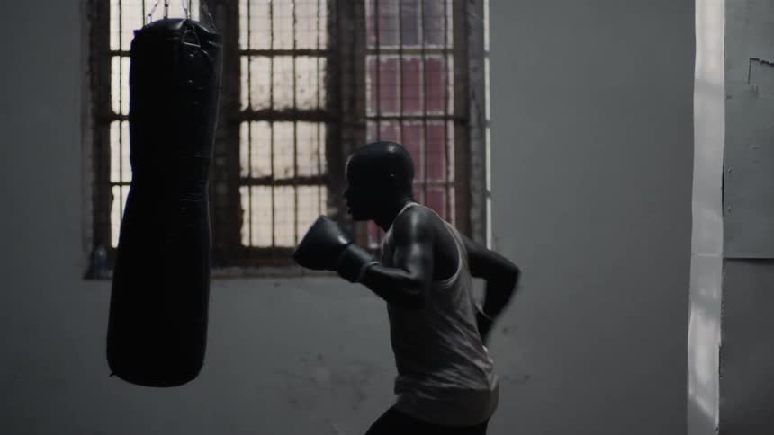 A boxer hits a punching bag