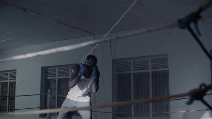 Man practices boxing jabs in a boxing ring