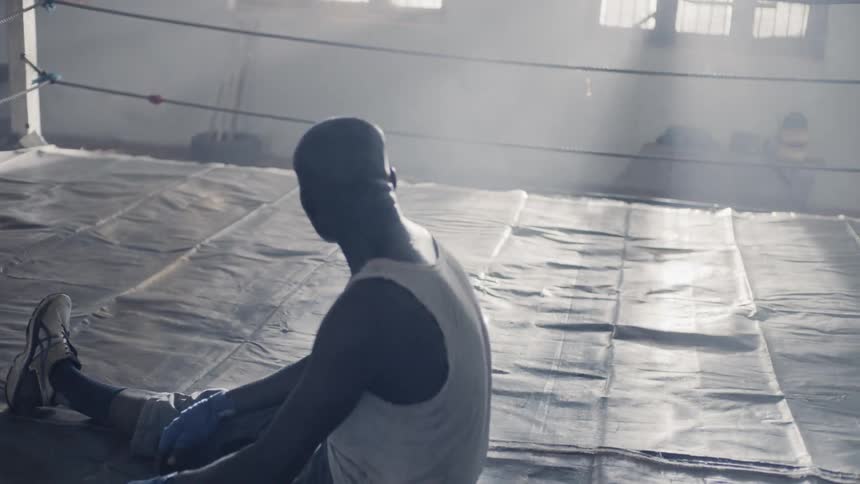 Man sits in a boxing ring