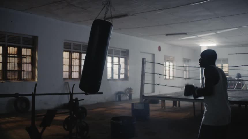 A boxer hits a punching bag