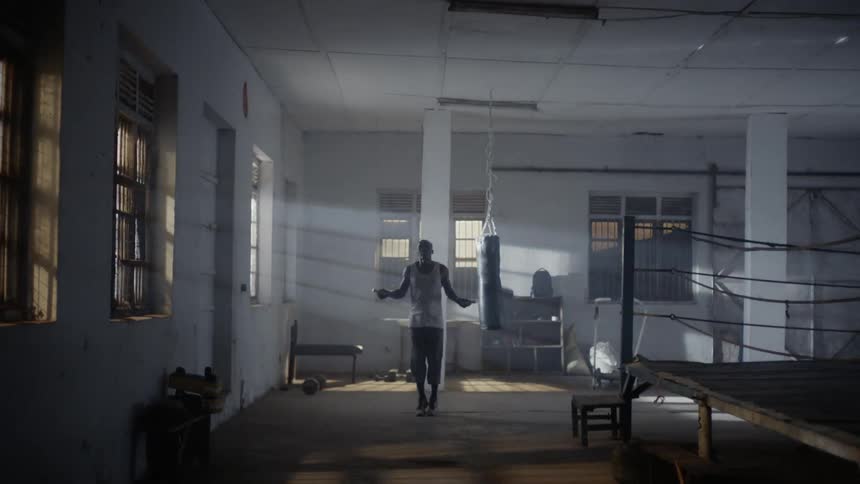Man jumps rope near a boxing ring