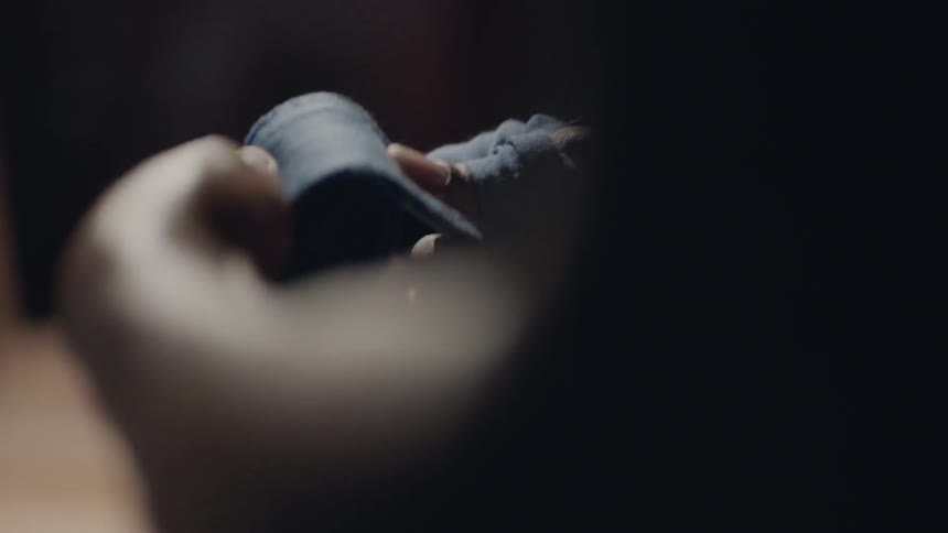 A man unrolls some tape in the gym