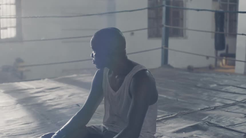 Man sits in a boxing ring