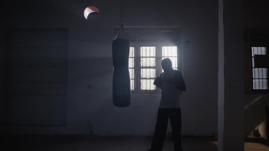 A boxer hits a punching bag