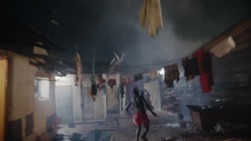Teenage chases a boy past huts at night