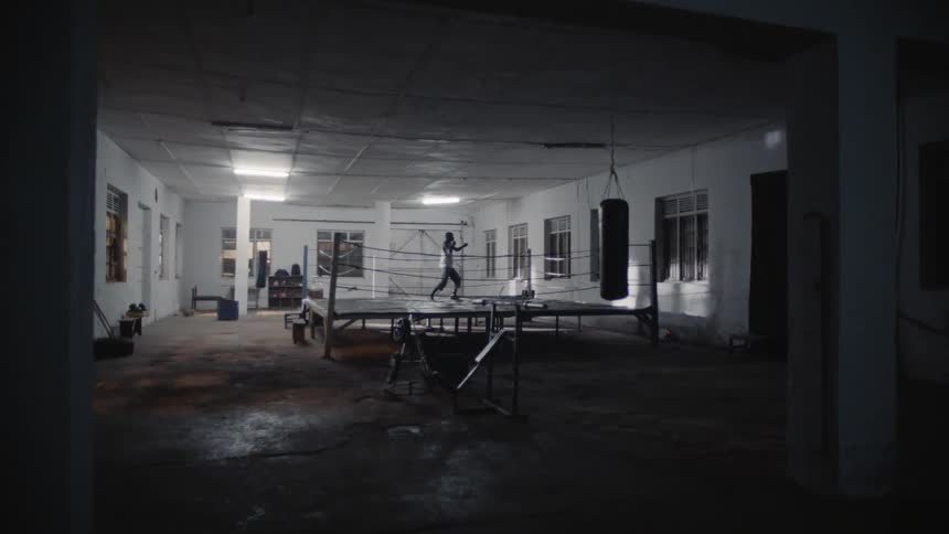 Man punches the air in a boxing ring