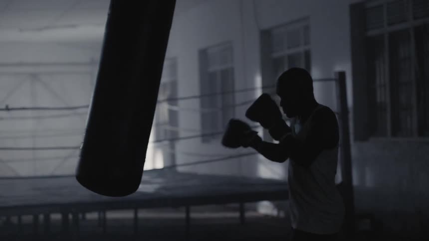 A boxer hits a punching bag