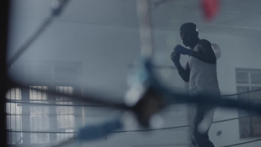 A man is shadowboxing in the ring