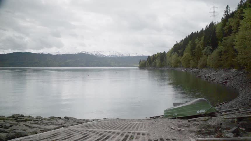 The lake water flows gently towards the boat ramp