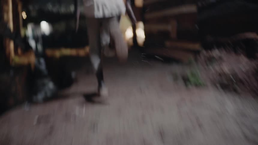 A child races in the village at night