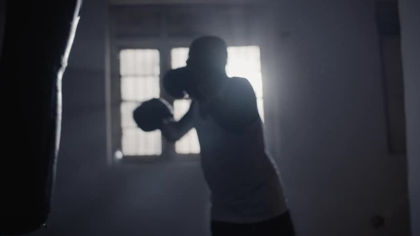 A boxer hits a punching bag