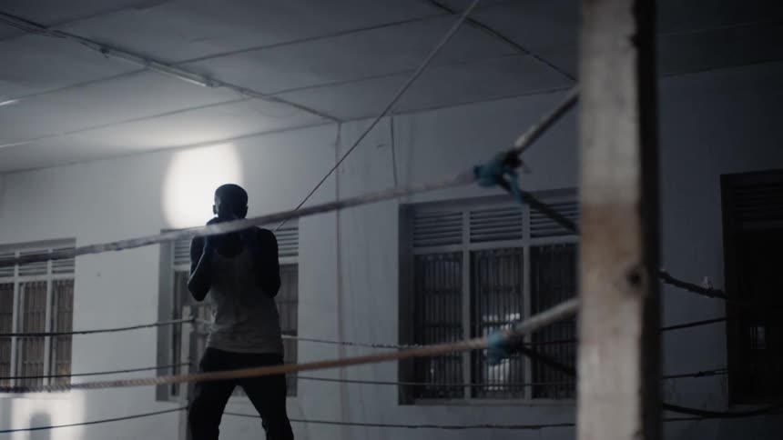 Man bounces in a boxing ring