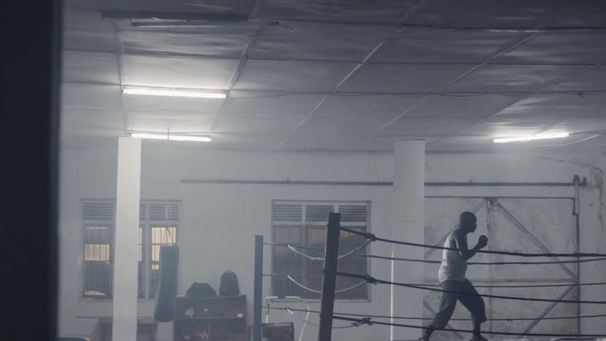 Man shadow boxes in a boxing gym