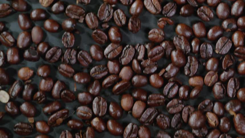 Coffee beans slide over the surface