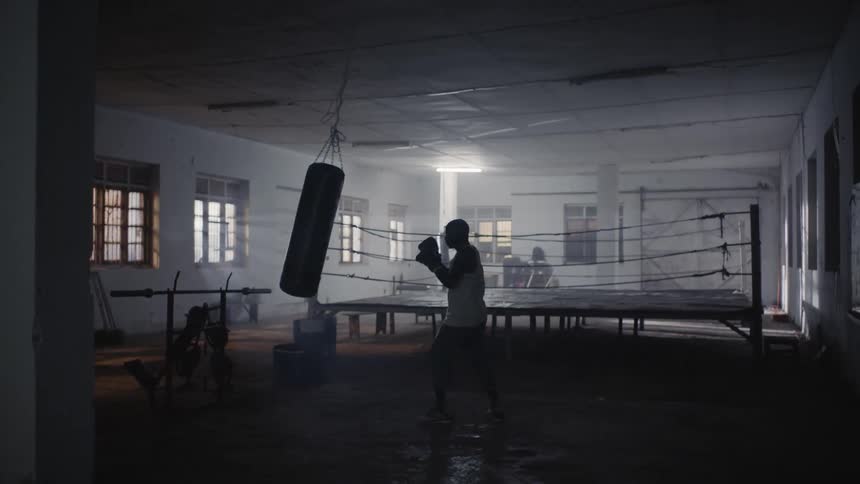 A boxer hits a punching bag