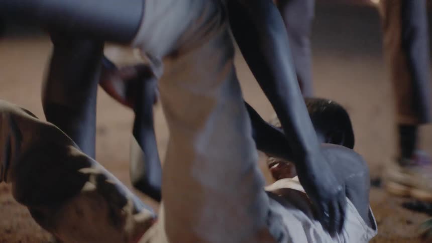 Group of boys being rough with another boy