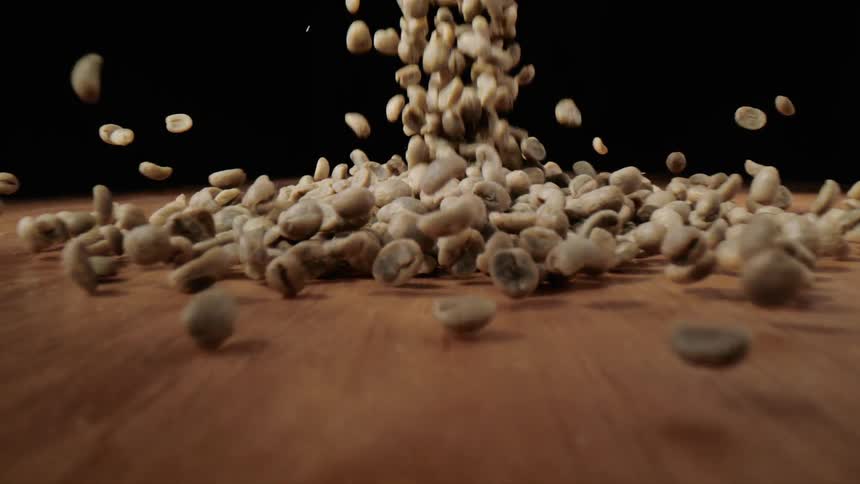 Large pile of peanuts fall onto a table