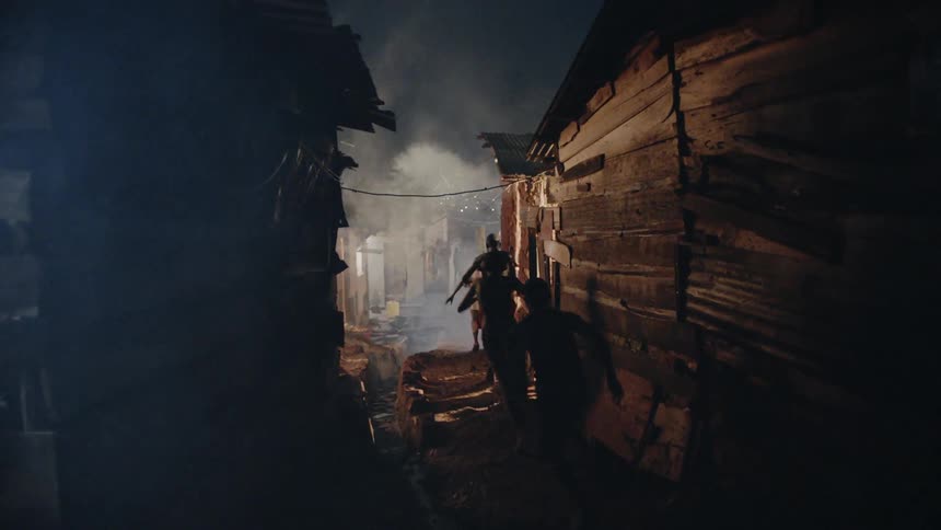 Boys run through a village at night