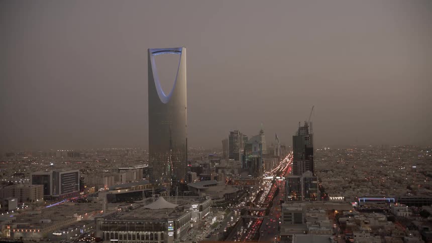 Riyadh sunset - Short and tall buildings in overcast city at dusk