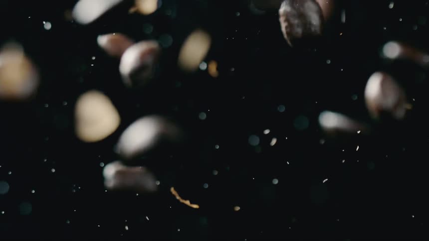 Coffee beans fall down and a fire blazes in the background